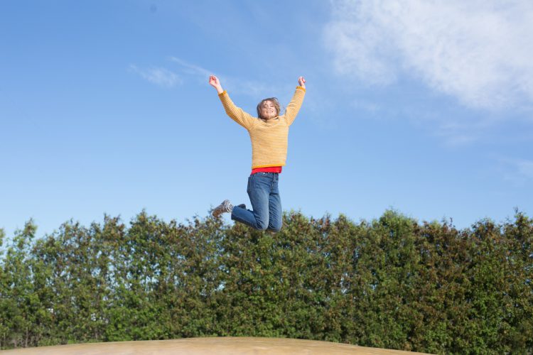 happy-woman-jumps-on-trampoline